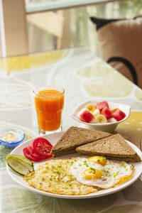 Healthy breakfast with fried eggs and fruit bowl in yangshuo