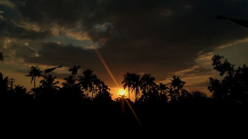 Silhouette trees against sky at sunset