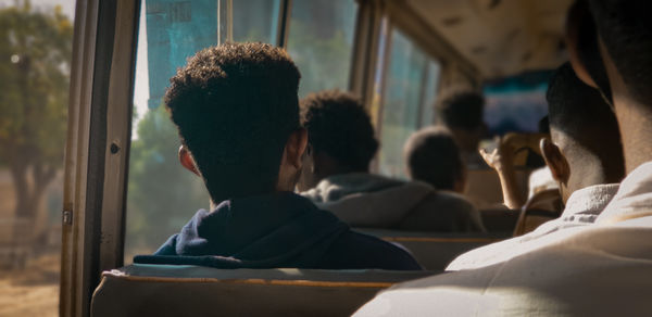 Rear view of people traveling in bus