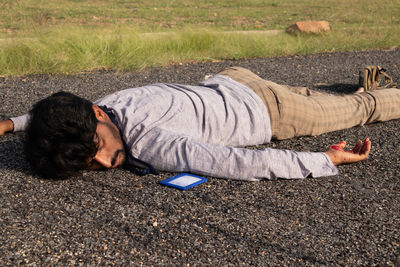 Young man sleeping on land