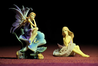 Close-up of statue against black background