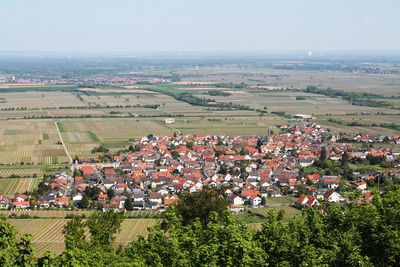 High angle view of houses in town against clear sky