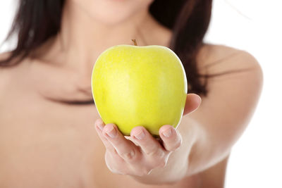 Close-up of woman holding apple