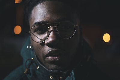 Close-up portrait of young man at night