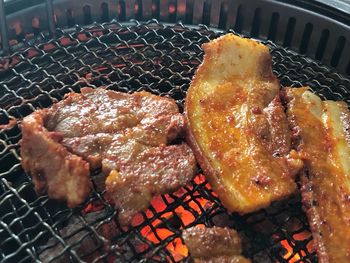 High angle view of meat on barbecue grill