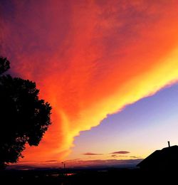 Scenic view of dramatic sky over silhouette landscape