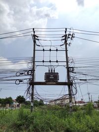 Low angle view of electricity pylon against sky