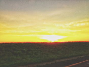 Scenic view of sunset over land