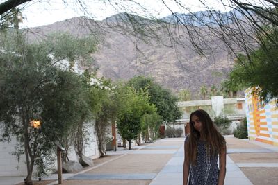 Young woman on road along trees