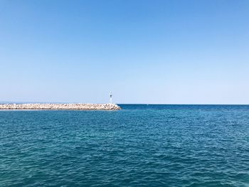 Scenic view of sea against clear blue sky