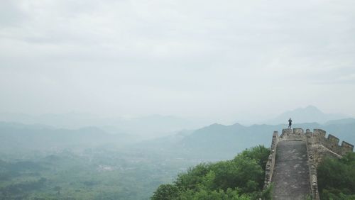 Scenic view of mountain against cloudy sky