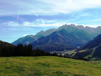 Scenic view of mountains against cloudy sky