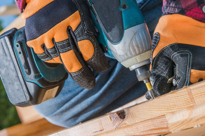 Midsection of carpenter working outdoors