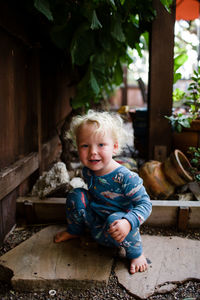 Portrait of smiling boy sitting outdoors