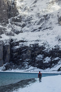 People on snow covered mountain against sky