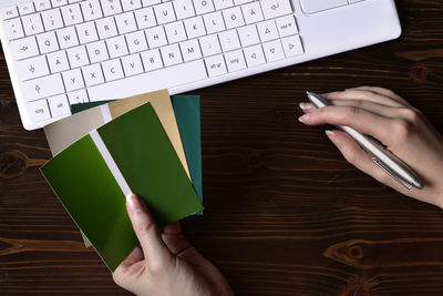 High angle view of woman using mobile phone on table