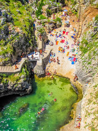 High angle view of people walking in water