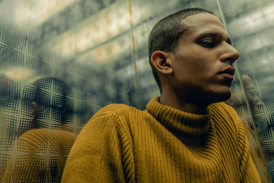 Portrait of young man looking away