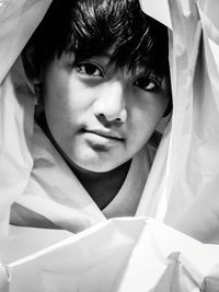 Close-up portrait of cute boy wrapped in textile