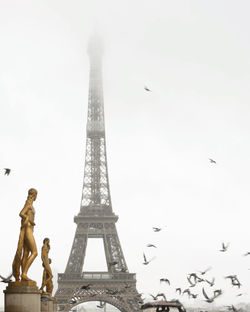 Low angle view of statue against cloudy sky