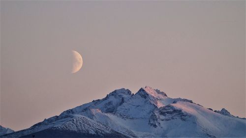 Scenic view of snowcapped mountains against clear sky