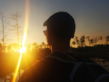 Rear view of man at sunset