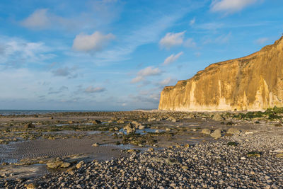 Rocks on beach against sky