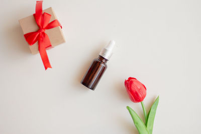 Close-up of red rose over white background