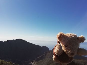 Close-up of stuffed toy against clear blue sky