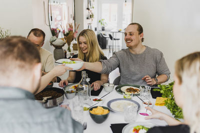 Group of friends having mexican food at home