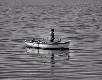 Man sitting in boat on lake