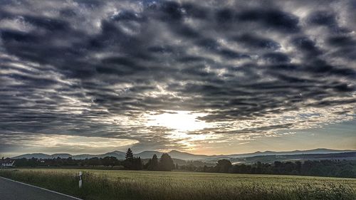 Scenic view of field against sky during sunset