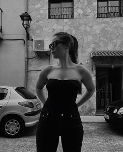 Portrait of young woman standing on street