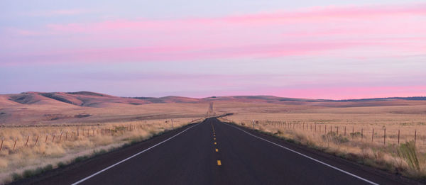 Road passing through landscape against sky