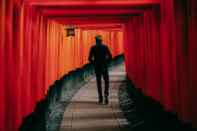 Rear view of man walking in temple