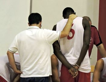Rear view of man standing in subway