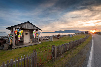 Scenic view of farm against sky during sunset