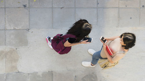 High angle view of women playing on wall