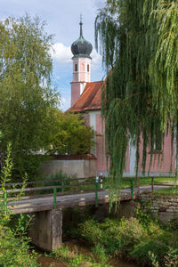 View of trees and building against sky