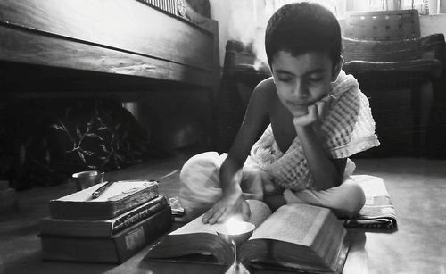 Boy reading books at home