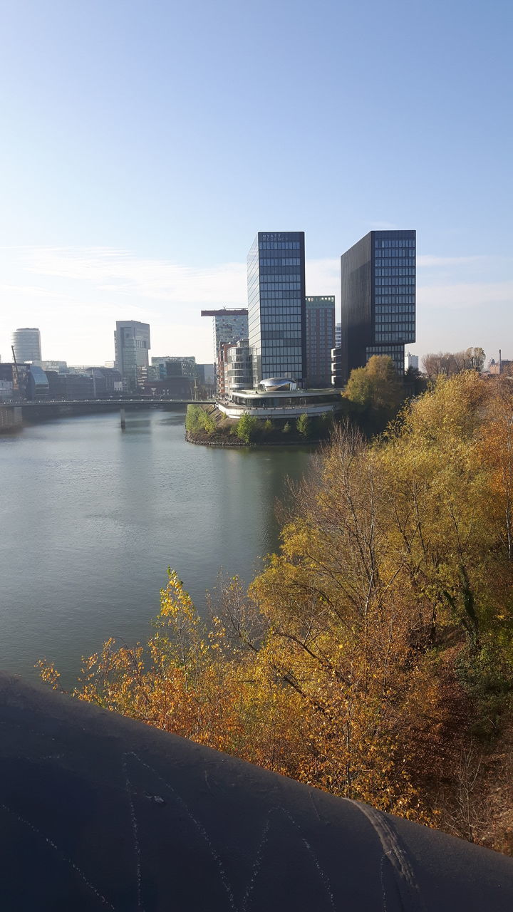 RIVER AND BUILDINGS AGAINST SKY