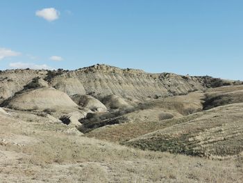 Scenic view of arid landscape against sky