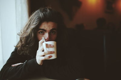 Portrait of mid adult man drinking glass