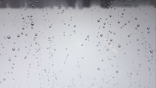 Full frame shot of raindrops on window