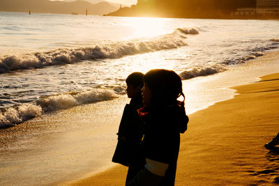 Couple on beach during sunset