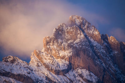 Low angle view of snowcapped mountain against sky