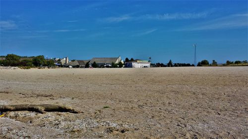 Scenic view of beach against blue sky