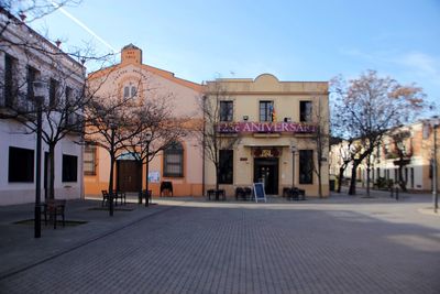 Houses by street against sky