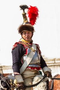 Portrait of man standing against wall