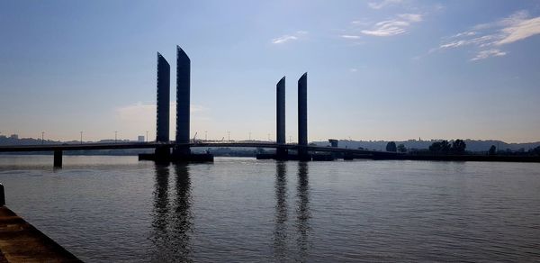 View of bridge over river at sunset